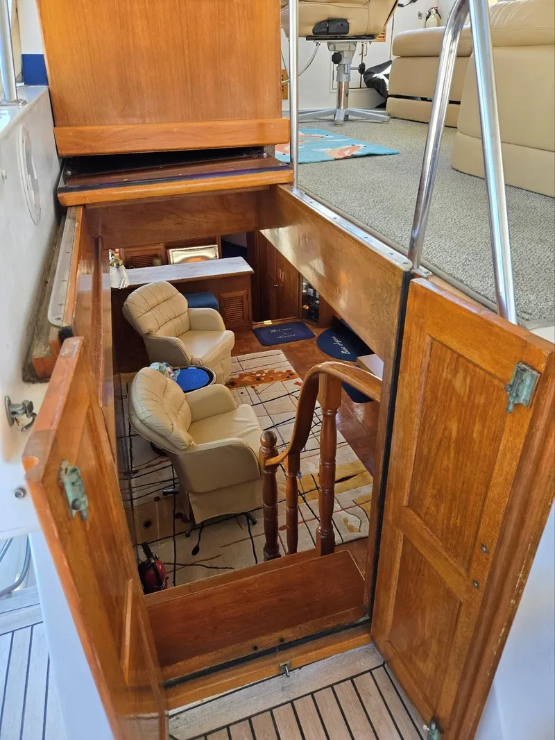 Slide: The Image of Interior view of 1983 Ocean Alexander 43 Flush Aft Deck yacht, featuring cozy seating and wooden finishes. - 32