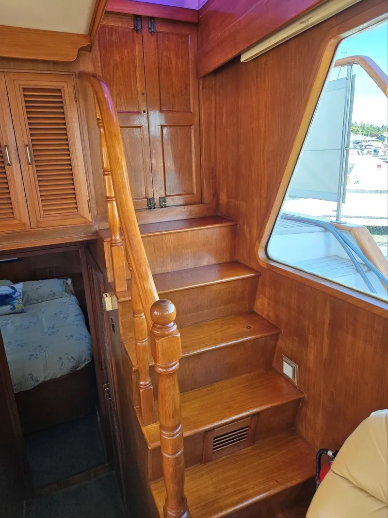 Slide: The Image of Wooden staircase and cabin interior of 1983 Ocean Alexander 43 Flush Aft Deck yacht. - 33
