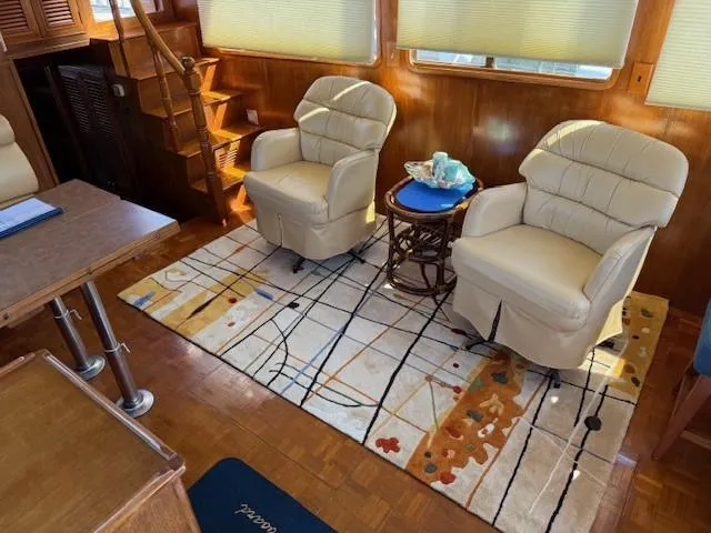 Slide: The Image of Interior of 1983 Ocean Alexander 43 yacht with plush chairs and decorative rug. - 35