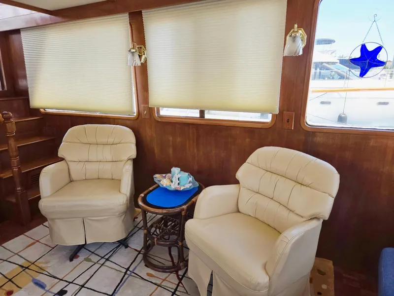 Slide: The Image of Interior of 1983 Ocean Alexander 43 yacht with plush chairs and nautical decor. - 36
