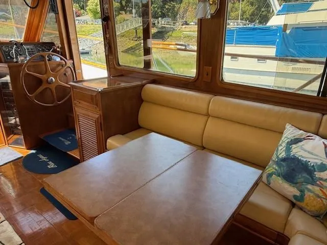 Slide: The Image of Interior of 1983 Ocean Alexander 43 Flush Aft Deck yacht with beige seating and wooden accents. - 37