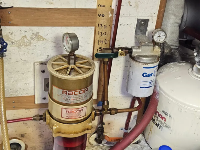 Slide: The Image of Engine room of 1983 Ocean Alexander 43 with Racor fuel filter and pressure gauge. - 47