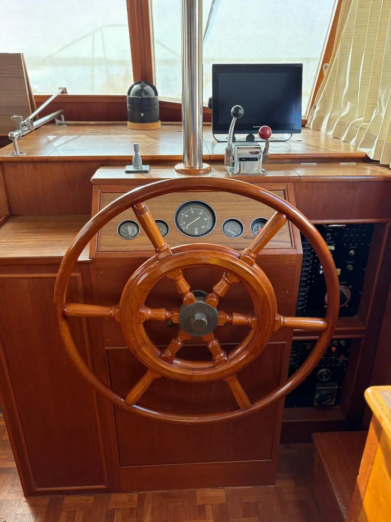 Slide: The Image of Wooden helm of 1986 Grand Banks 36 Classic yacht with gauges and controls. - 10
