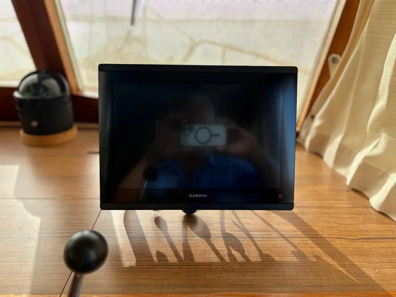 Slide: The Image of Garmin screen on 1986 Grand Banks 36 Classic boat dashboard, reflecting interior. - 13