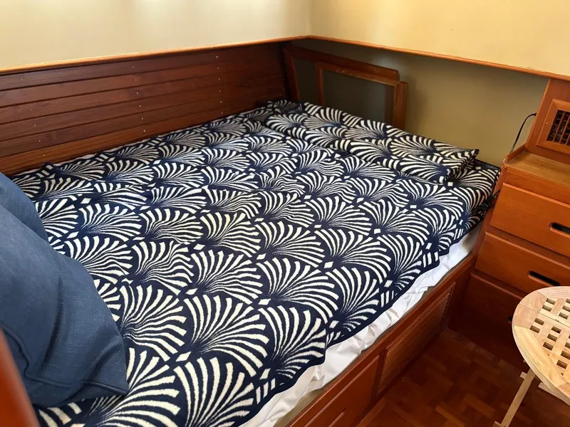 Slide: The Image of Cozy cabin bed with patterned blanket on 1986 Grand Banks 36 Classic boat. - 15