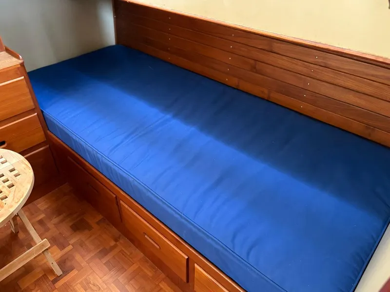 Slide: The Image of Wooden cabin interior with blue mattress on a 1986 Grand Banks 36 Classic boat. - 17