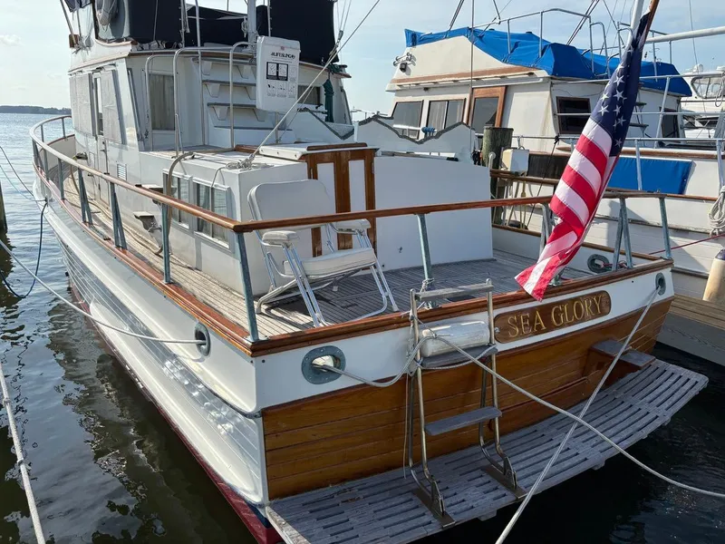 Slide: The Image of 1986 Grand Banks 36 Classic yacht "Sea Glory" docked with American flag. - 2