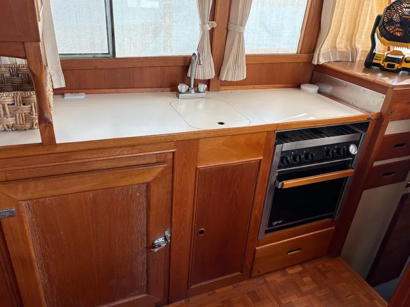 Slide: The Image of Wooden kitchen interior of 1986 Grand Banks 36 Classic boat with stove and sink. - 21