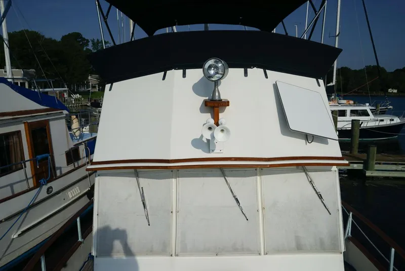 Slide: The Image of 1986 Grand Banks 36 Classic yacht docked at marina, featuring upper deck and spotlight. - 3