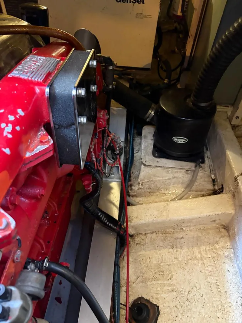 Slide: The Image of Engine compartment of a 1986 Grand Banks 36 Classic boat, featuring red engine components. - 31