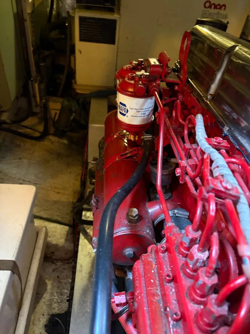 Slide: The Image of Engine room of 1986 Grand Banks 36 Classic with red engine components. - 32