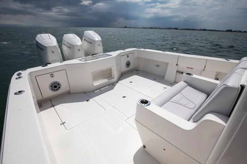 Slide: The Image of 2024 SeaVee Open Fisherman 390Z boat with triple Mercury engines on open water. - 13