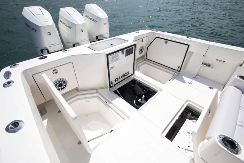 Slide: The Image of 2024 SeaVee Open Fisherman 390Z boat deck with storage compartments and Mercury engines. - 14