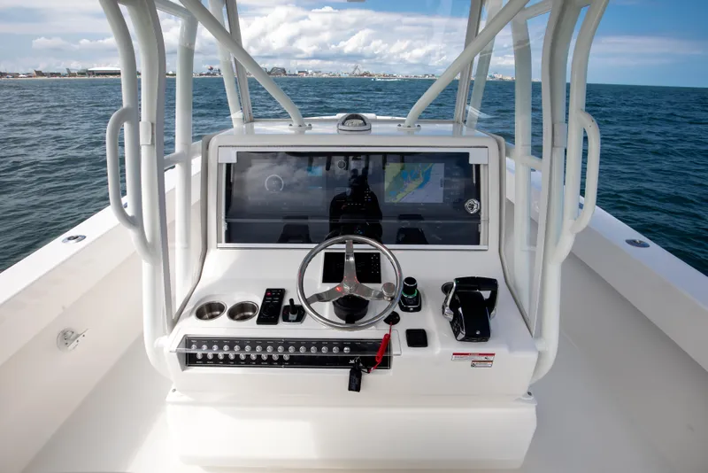 Slide: The Image of 2024 SeaVee Open Fisherman 390Z helm with modern navigation system on open water. - 16
