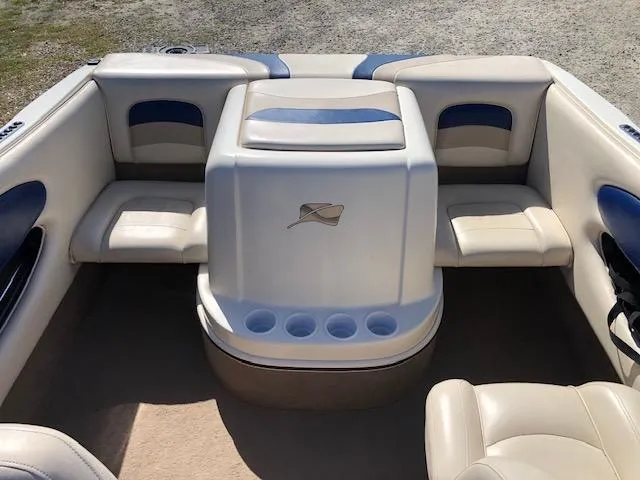 Slide: The Image of 2001 Stingray 180 LS/LX boat interior with beige and blue seating. - 11