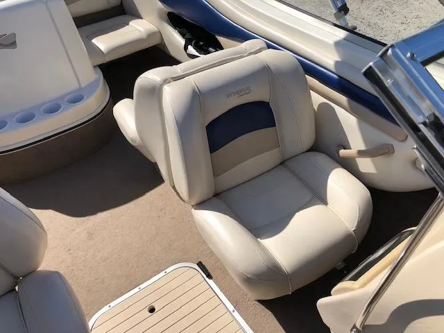 Slide: The Image of 2001 Stingray 180 LS/LX boat interior with beige seating and blue accents. - 16