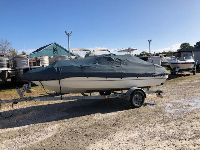 Slide: The Image of 2001 Stingray 180 LS/LX boat covered on trailer in outdoor storage. - 28