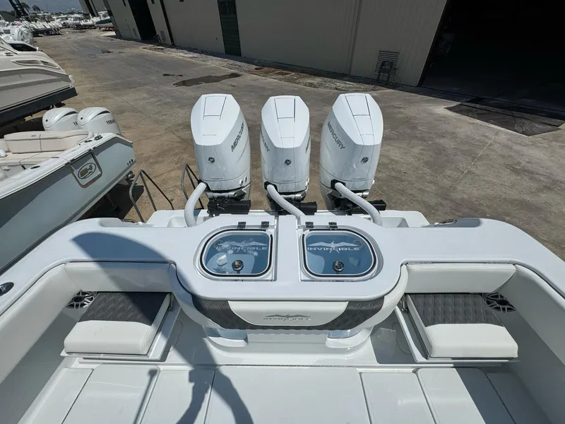 Slide: The Image of 2026 Invincible 43 Open Fisherman with triple Mercury engines at a marina. - 10