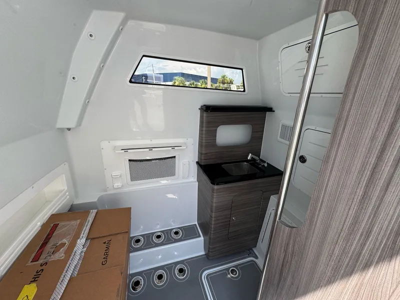 Slide: The Image of Interior of 2026 Invincible 43 Open Fisherman boat with sink and storage. - 16