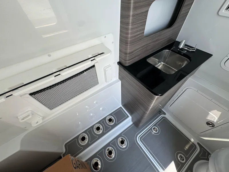 Slide: The Image of Interior of 2026 Invincible 43 Open Fisherman with sink and storage compartments. - 19