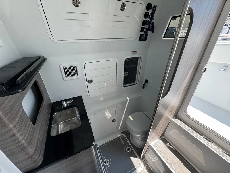 Slide: The Image of Interior of 2026 Invincible 43 Open Fisherman boat with sink and toilet. - 20