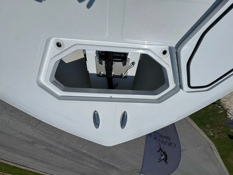 Slide: The Image of 2026 Invincible 43 Open Fisherman boat deck with open hatch and visible hardware. - 27