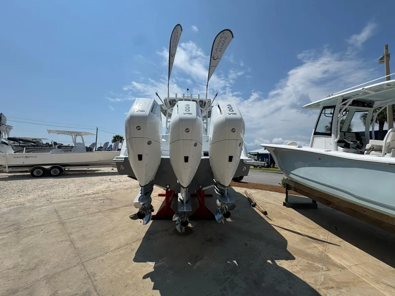 Slide: The Image of 2026 Invincible 43 Open Fisherman with triple outboard engines, displayed outdoors. - 3