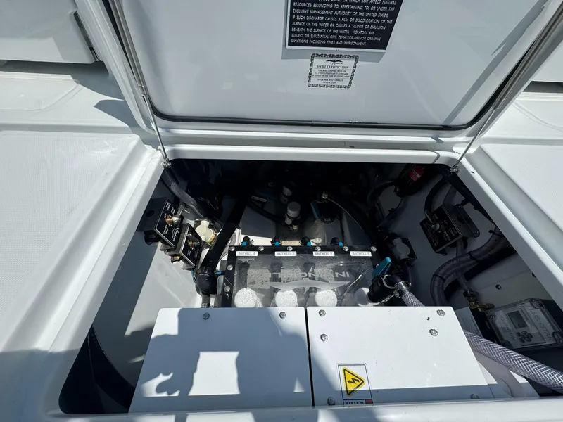 Slide: The Image of Engine compartment of 2026 Invincible 43 Open Fisherman boat, showcasing mechanical components. - 31