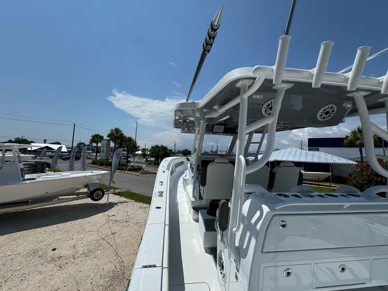 Slide: The Image of 2026 Invincible 43 Open Fisherman boat displayed outdoors under clear blue sky. - 33