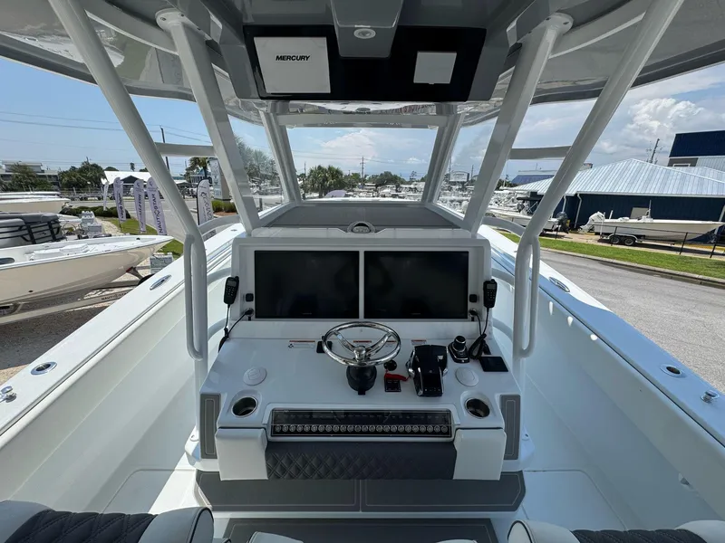 Slide: The Image of 2026 Invincible 43 Open Fisherman boat cockpit with modern controls and dual screens. - 35