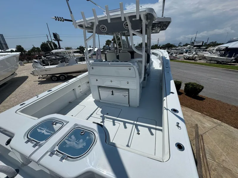 Slide: The Image of 2026 Invincible 43 Open Fisherman boat, spacious deck, sleek design, marina background. - 40