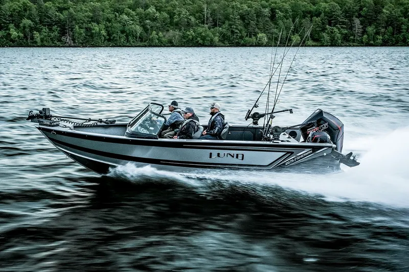 Slide: The Image of Manufacturer Provided Image: 2025 Lund 2075 Fisherman boat speeding on a lake with anglers onboard. - 16