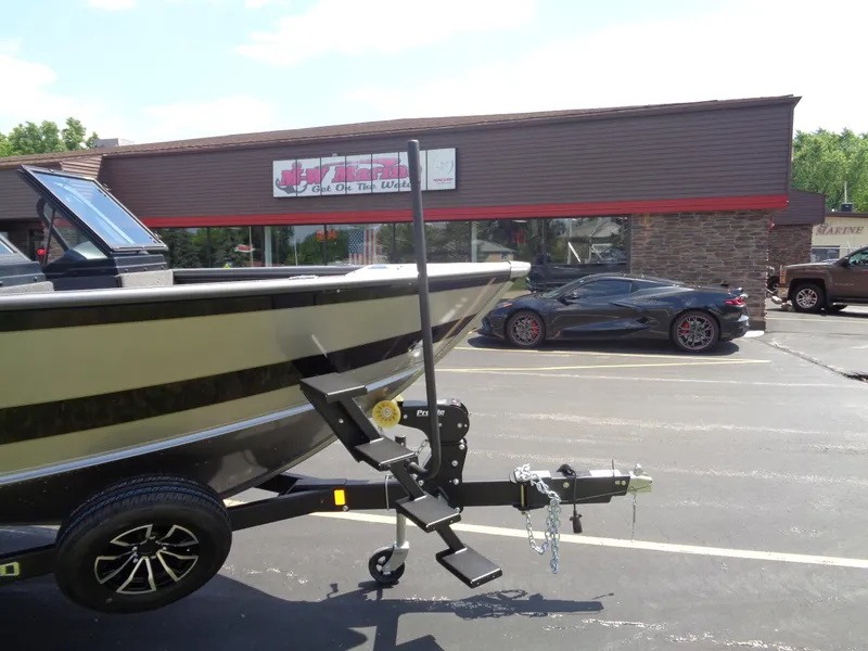 Slide: The Image of 2025 Lund 2075 Fisherman boat on trailer in parking lot near sports car. - 7