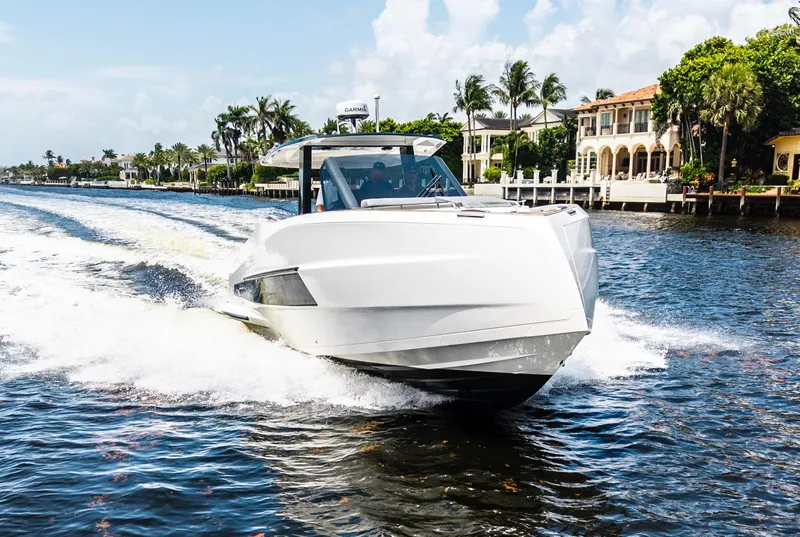 The Image of 2024 Astondoa 377 yacht cruising on a sunny day near waterfront homes. - 0