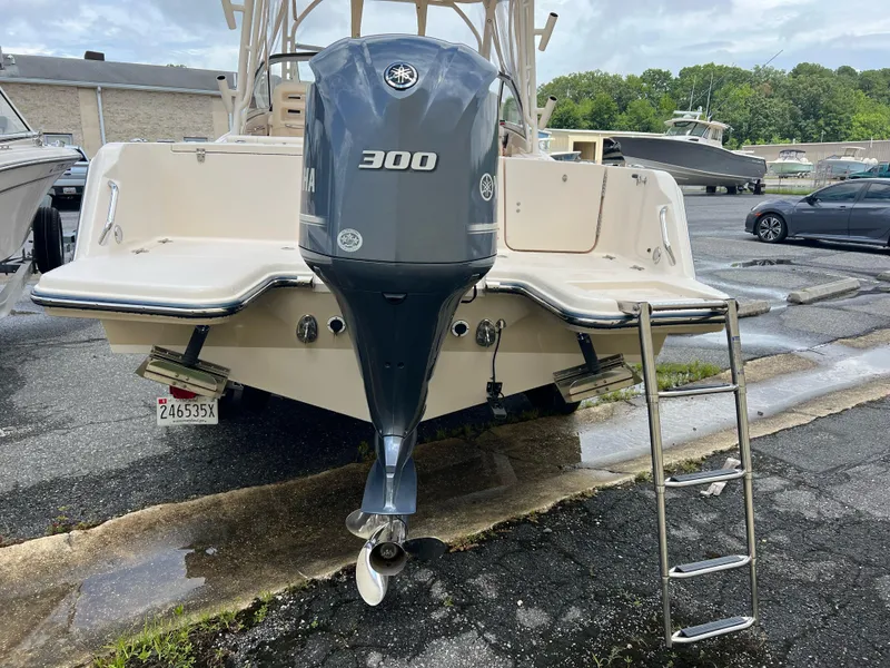 Slide: The Image of 2019 Grady-White Freedom 235 boat with Yamaha 300 engine and ladder, parked outdoors. - 3