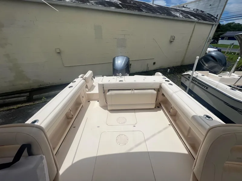 Slide: The Image of 2019 Grady-White Freedom 235 boat interior with seating and outboard motor. - 6