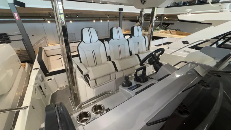 Slide: The Image of 2024 Jeanneau Leader 12.5 WA boat interior with modern seating and control panel. - 10
