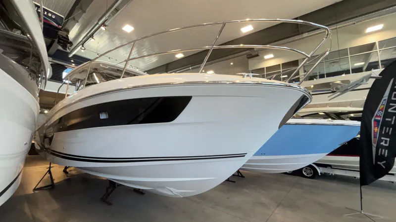Slide: The Image of 2024 Jeanneau Leader 12.5 WA boat displayed in a showroom. - 11