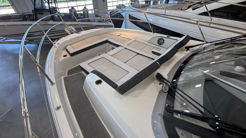 Slide: The Image of 2024 Jeanneau Leader 12.5 WA boat interior with cushioned seating and sleek design. - 4