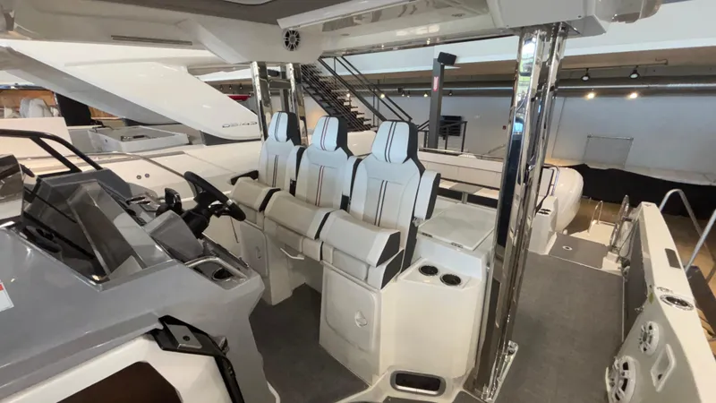 Slide: The Image of 2024 Jeanneau Leader 12.5 WA boat interior with modern seating and helm station. - 5