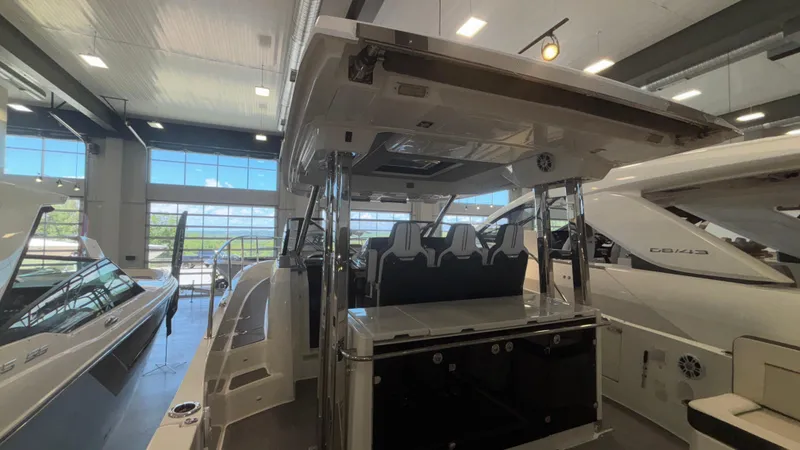 Slide: The Image of 2024 Jeanneau Leader 12.5 WA boat displayed in a showroom, featuring sleek design and modern amenities. - 6