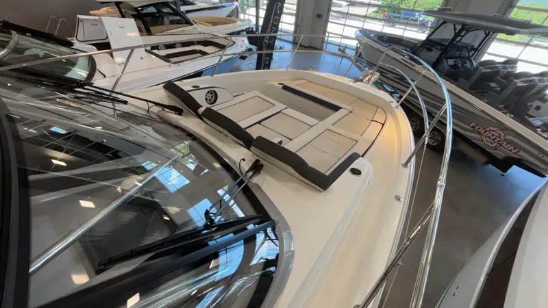 Slide: The Image of 2024 Jeanneau Leader 12.5 WA boat displayed in showroom, featuring sleek design and spacious deck. - 9