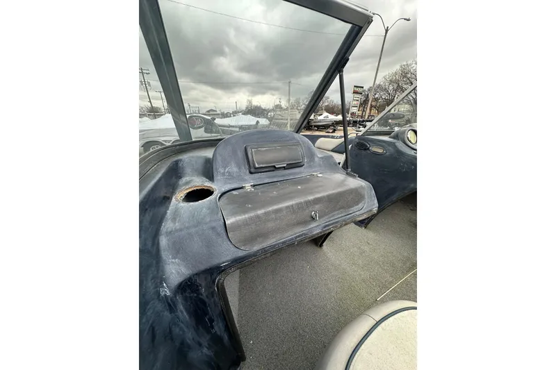 Slide: The Image of 2007 Stratos 486 Ski-N-Fish boat interior with dashboard and windshield, under cloudy sky. - 18