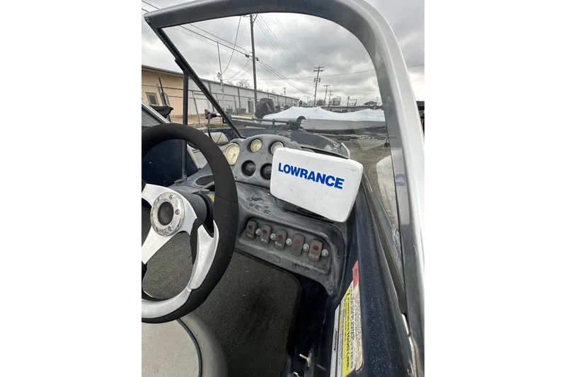 Slide: The Image of 2007 Stratos 486 Ski-N-Fish boat dashboard with Lowrance equipment and steering wheel. - 23