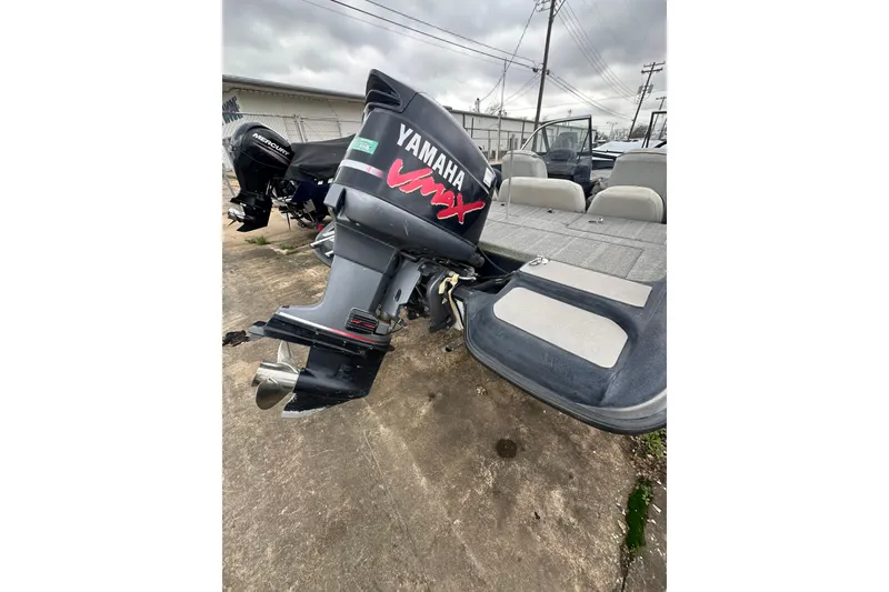 Slide: The Image of 2007 Stratos 486 Ski-N-Fish boat with Yamaha outboard motor, parked outdoors. - 24