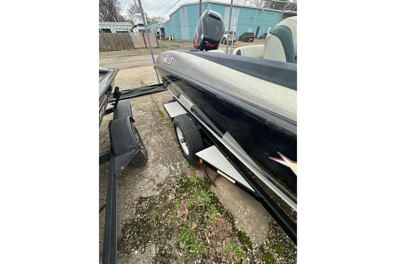 Slide: The Image of 2007 Stratos 486 Ski-N-Fish boat on trailer, parked outdoors. - 25