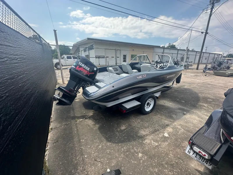 Slide: The Image of 2007 Stratos 486 Ski-N-Fish boat with Yamaha engine on trailer, parked outdoors. - 5