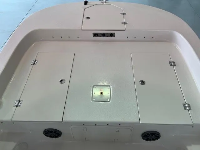 Slide: The Image of 2025 Carolina Skiff 23 LS boat deck with storage compartments and speakers. - 11