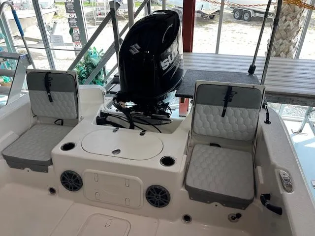 Slide: The Image of 2025 Carolina Skiff 23 LS boat interior with seating and outboard motor. - 3