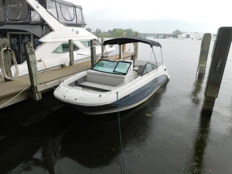 The Image of 2021 Sea Ray SDX 250 boat docked at a marina on a cloudy day. - 1